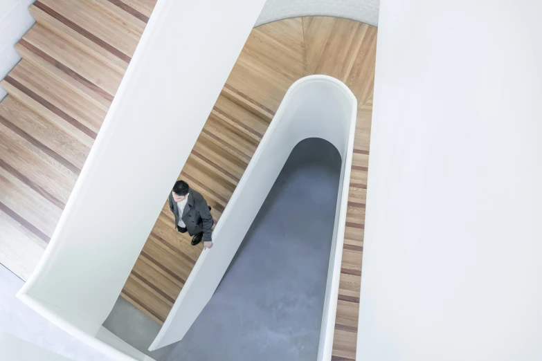 a person standing at the bottom of an open staircase