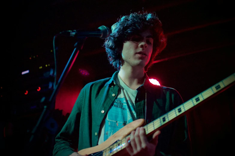 a man playing an electric guitar on stage