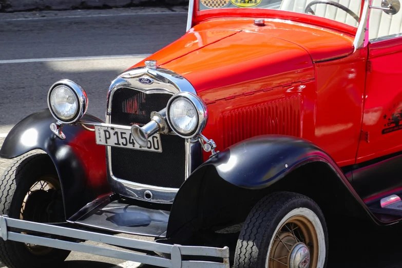 a red and black car parked on the street