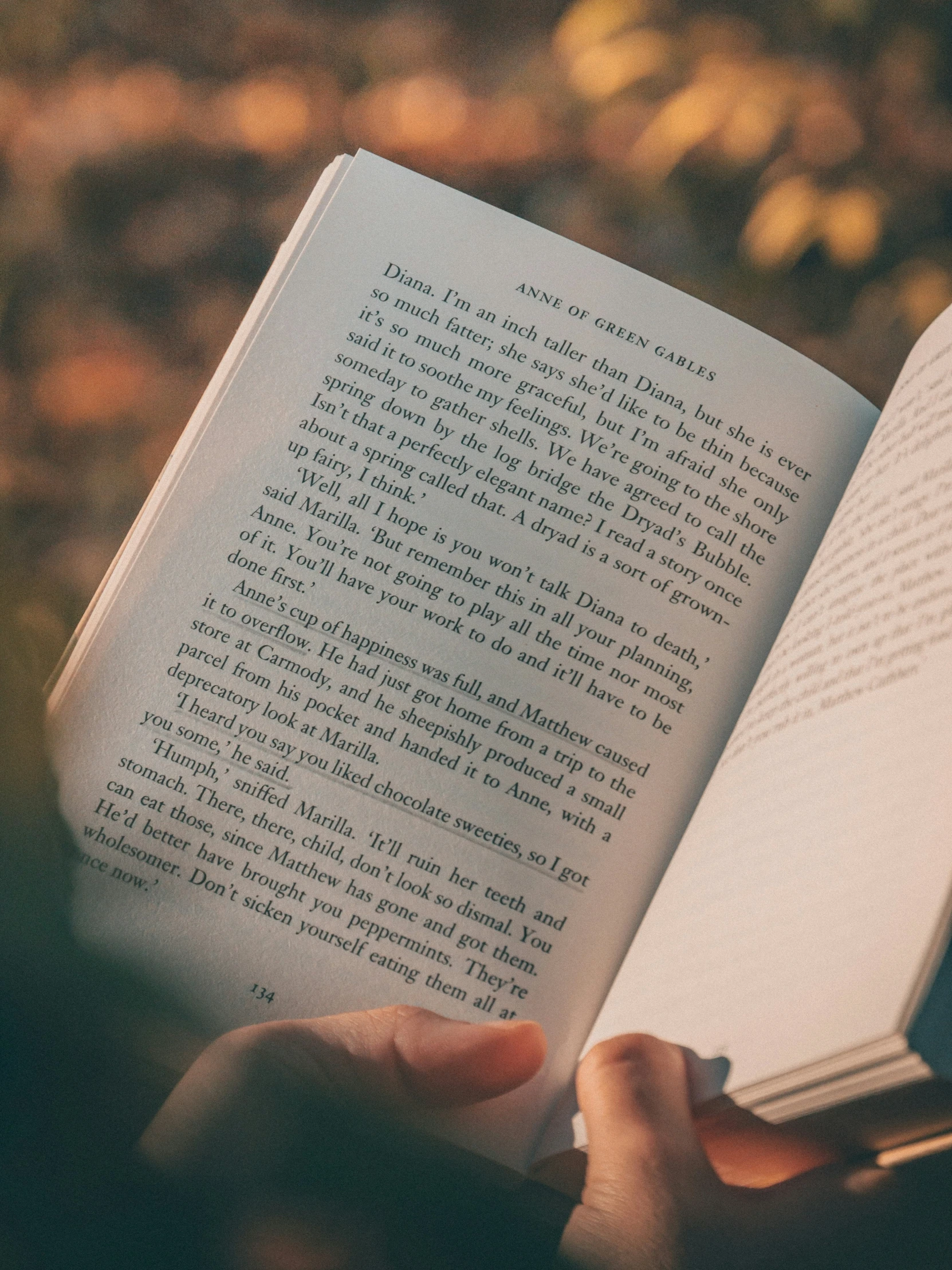 the open book is visible against an outdoor background