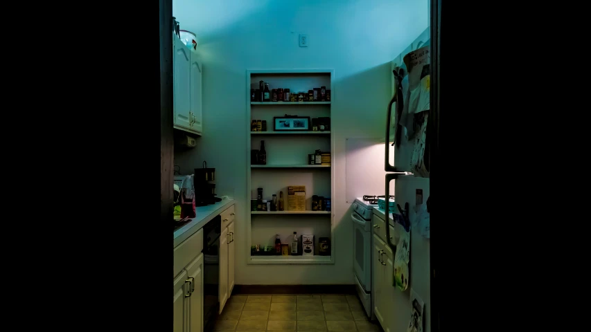 an open door leading to a kitchen with cabinets