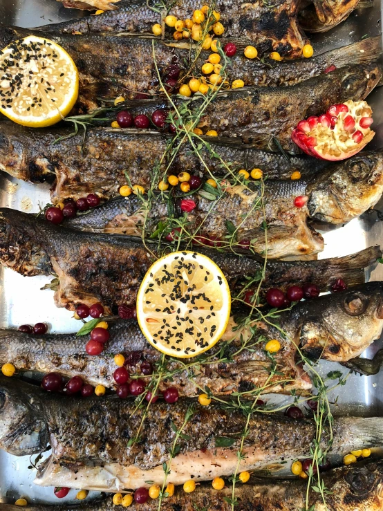 this meal consists of baked fish, lemons, and herbs