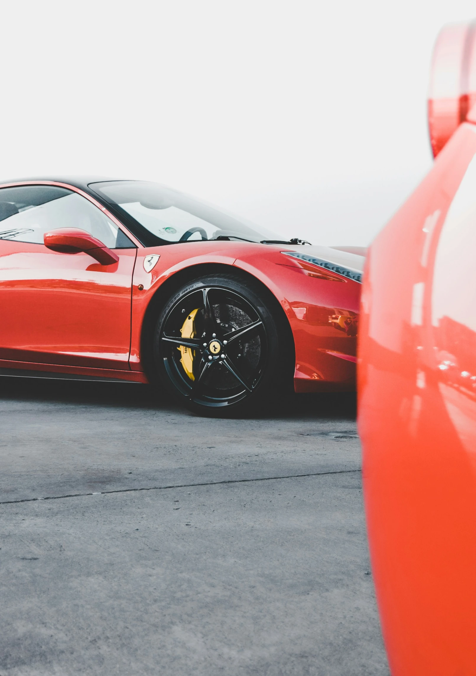 the red sports car is parked in front of a bright red object