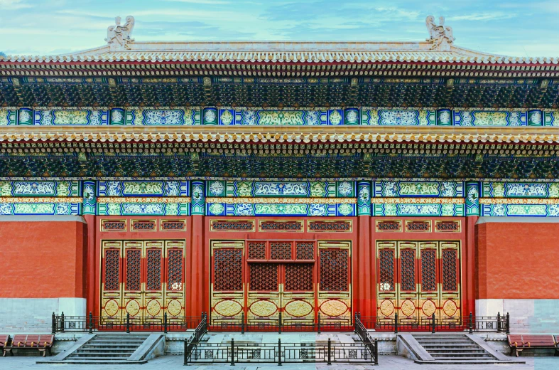 the entrance to a temple with red walls and windows