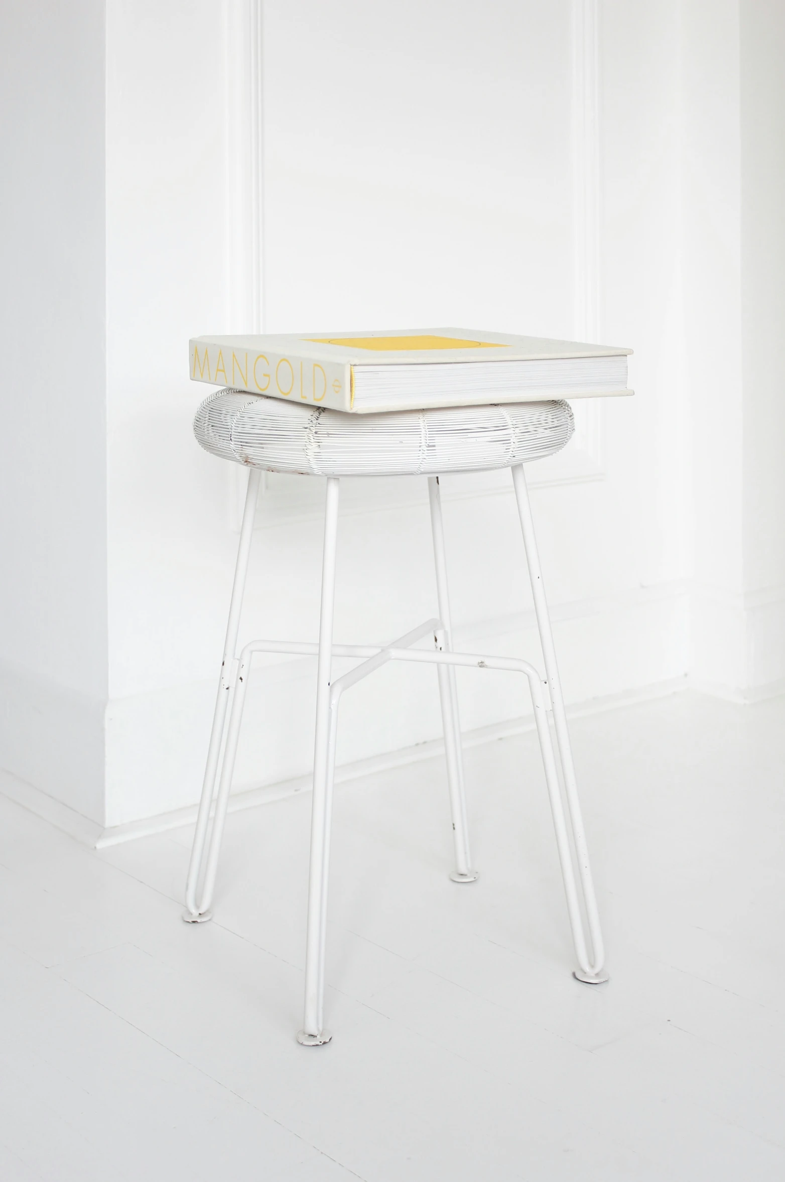 an oval table with metal legs, painted yellow