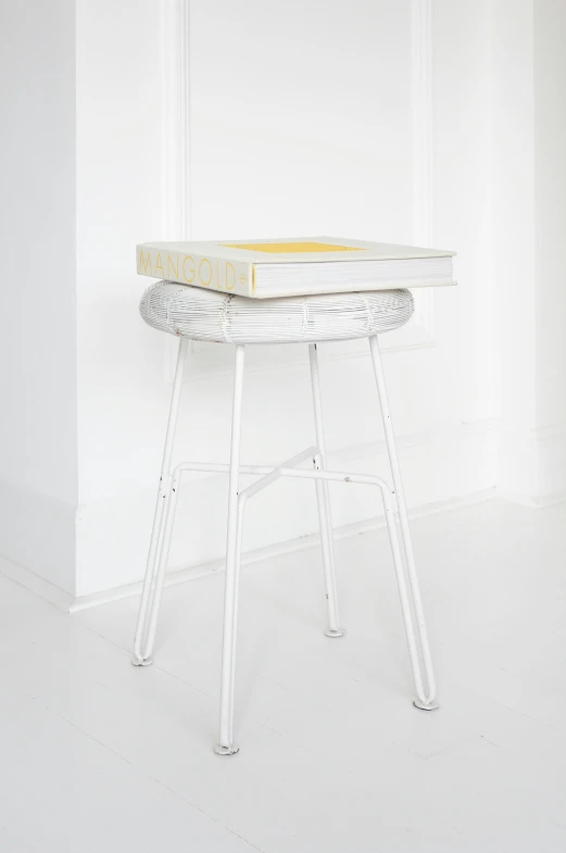 an oval table with metal legs, painted yellow