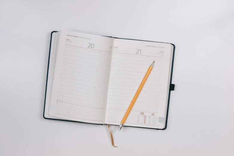 a journal and pen laying on a desk