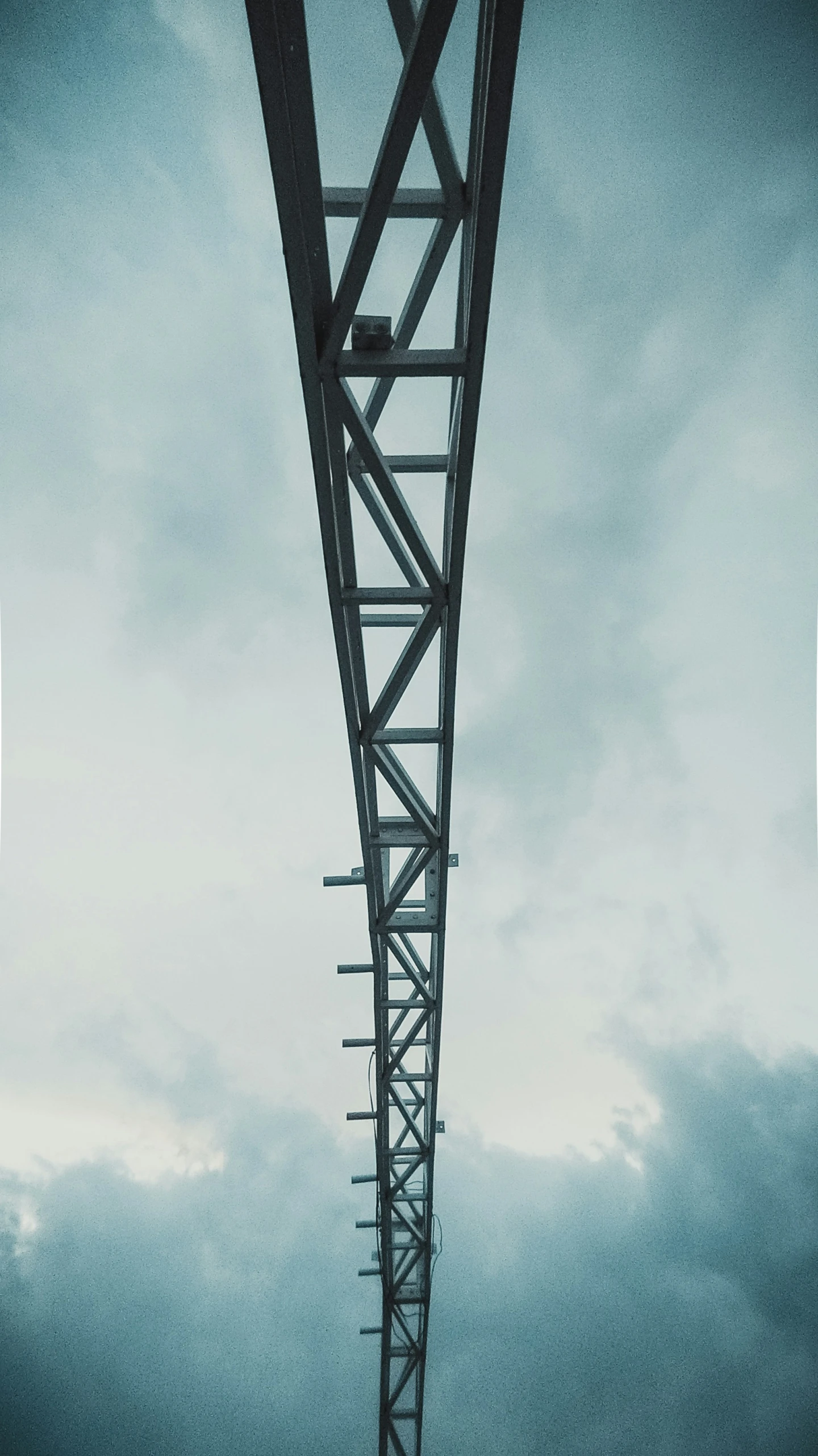 the view of the bridge from below it with a cloudy sky