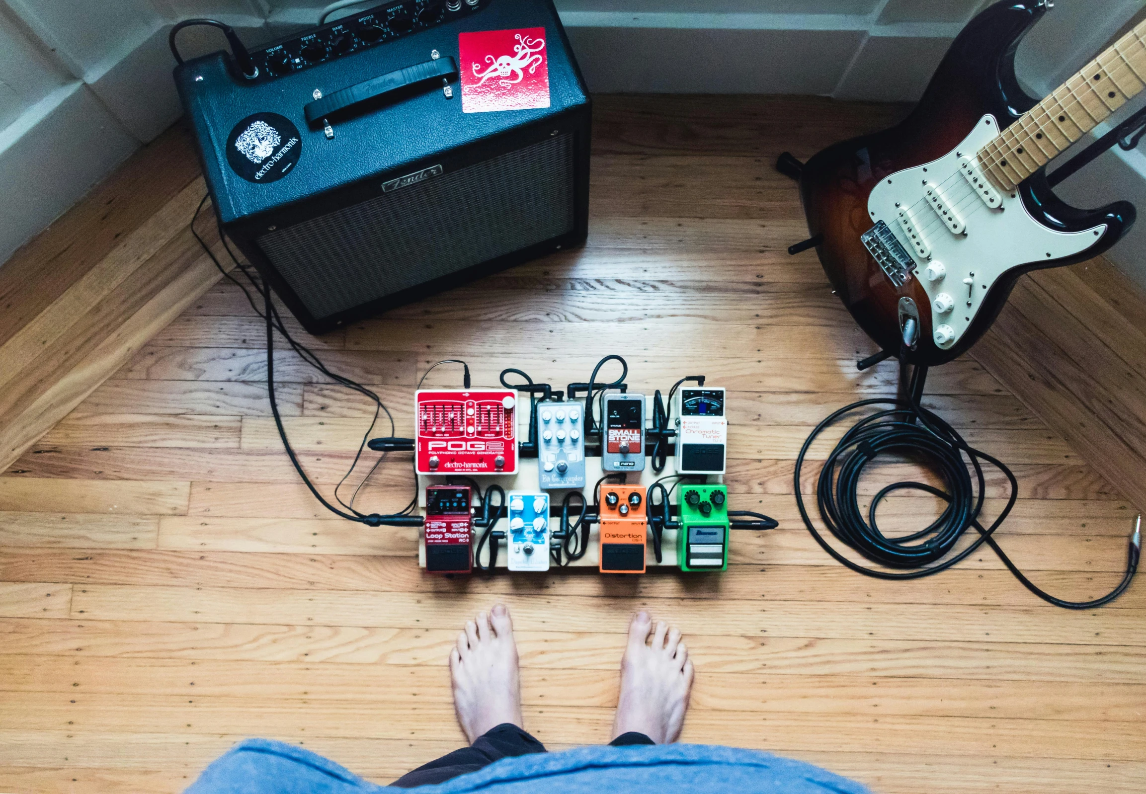 a person standing next to a guitar, amp and sound equipment