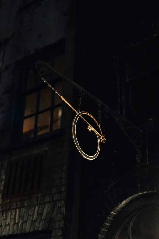 a clock sitting outside a building lit up by the moon