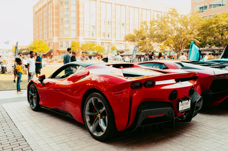 two red sports cars parked on the side of the street