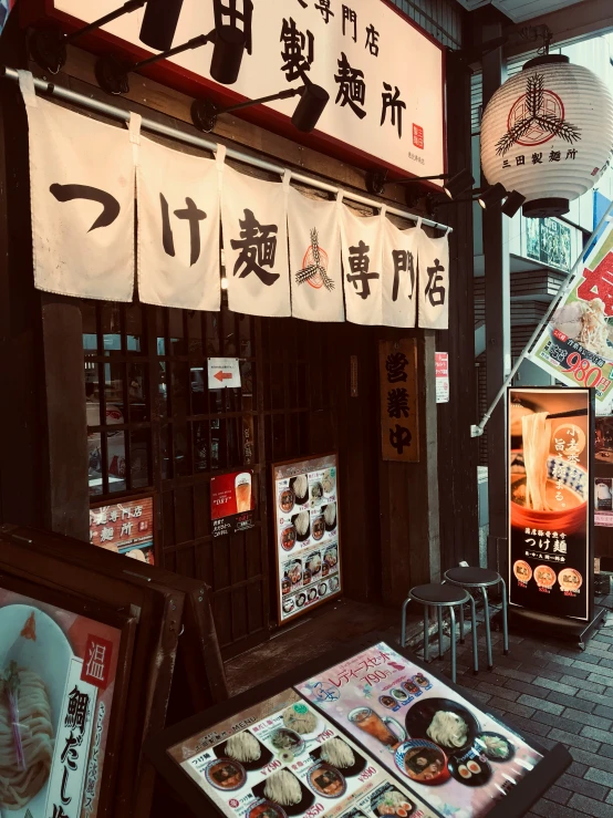 an asian food shop has chinese writing on signs