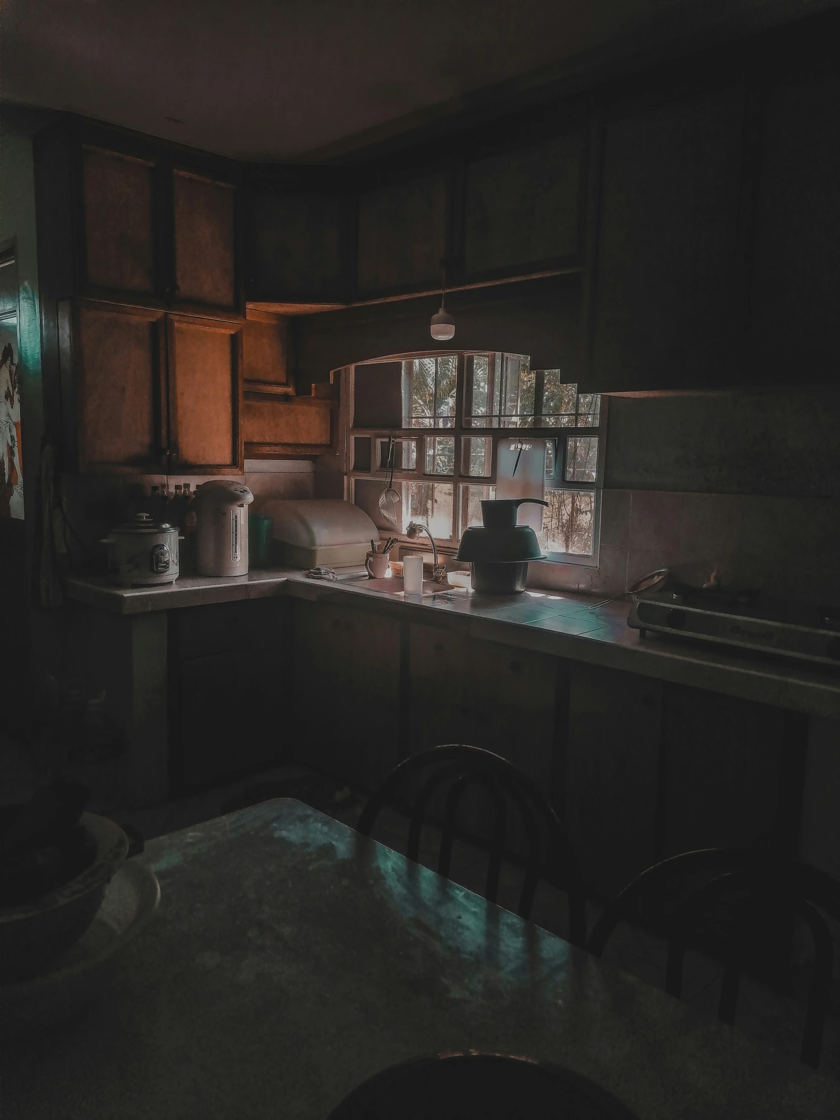 an old kitchen in the dark with glowing tile on the walls