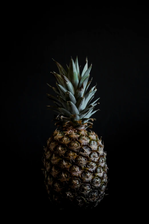 a close up of a pineapple on a black background