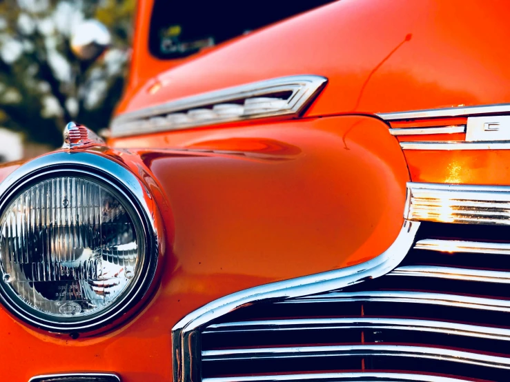 the front end of a classic car with a skull on it's headlight