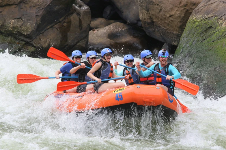 a group of people on raft going through rapids