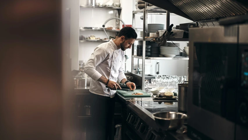 a man stands in front of a  board with food on it