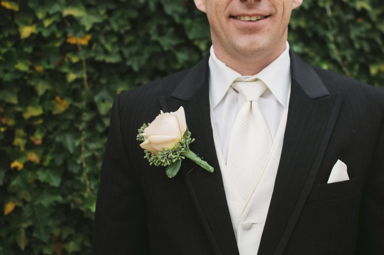 an image of a man in a suit that has a rose on it