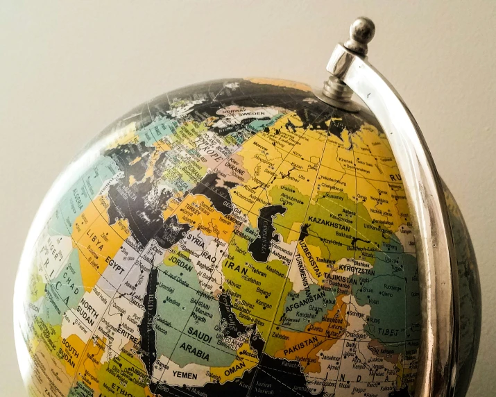 a globe of the world is shown with a clock