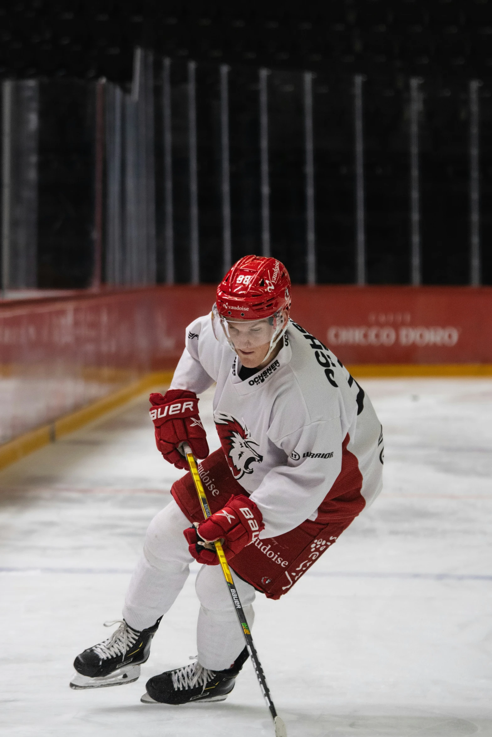 a man with a hockey stick on a hockey court