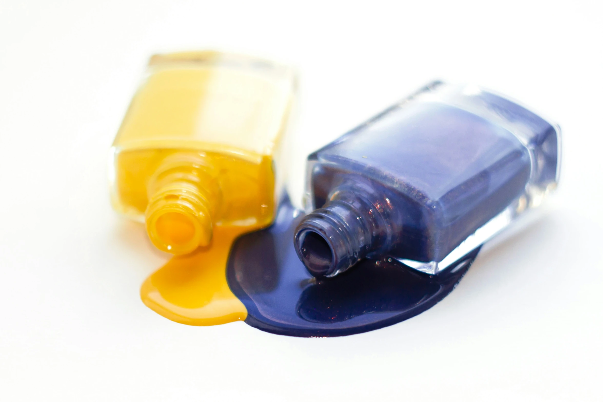 an orange bottle next to a yellow bottle with a blue lid