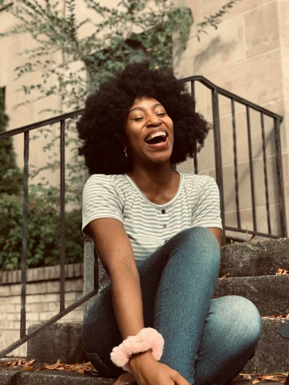young lady laughing in front of her stairs