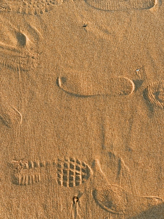 sand with a piece of orange material in it