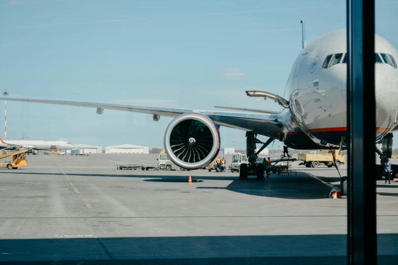 a large commercial plane sits on the runway