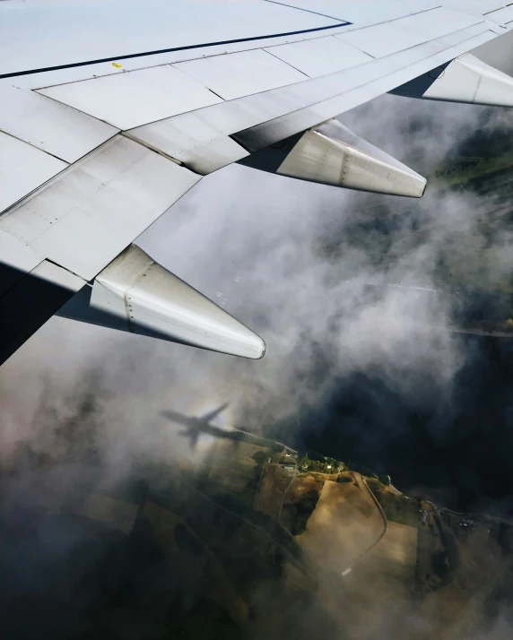 a wing of an airplane in flight above the clouds