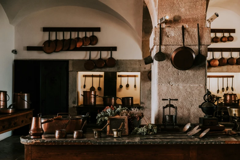 a kitchen has pots and pans on the wall