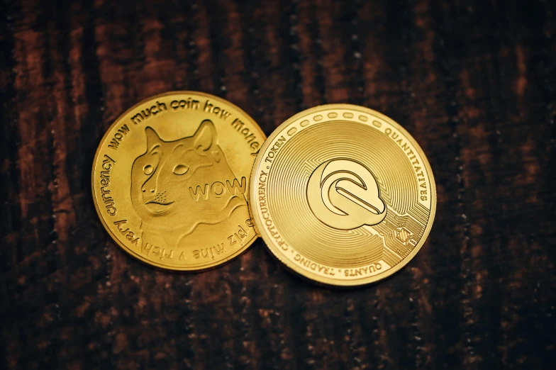 a close up of two coin sitting on a wooden surface