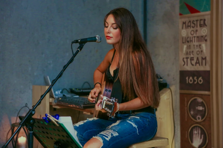 a girl sitting on top of a chair with a guitar