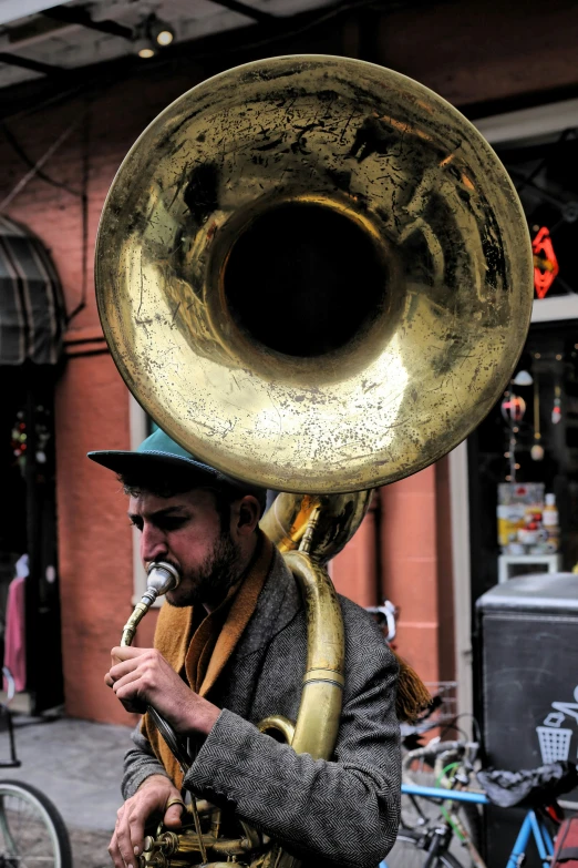 a man is playing a musical instrument while standing in front of bikes