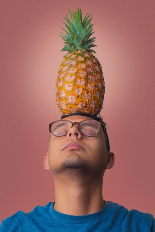 a man with a pineapple over his head