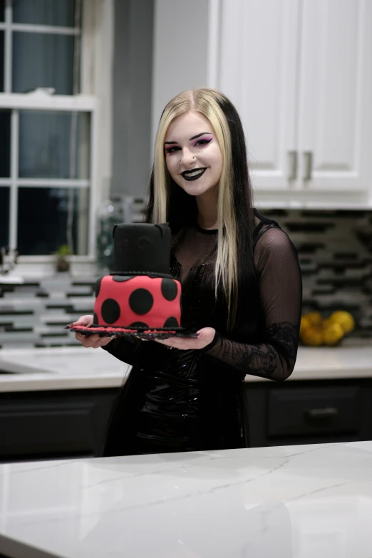 the girl with makeup is holding a cake