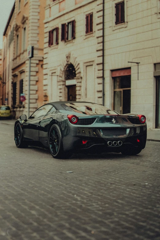 the rear end of a sports car in a parking lot