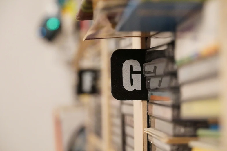 the magnets are shaped like the letters g and g on a book shelf