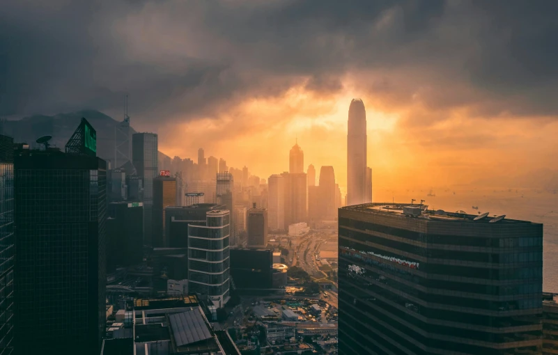 a cloudy day in a big city next to the ocean