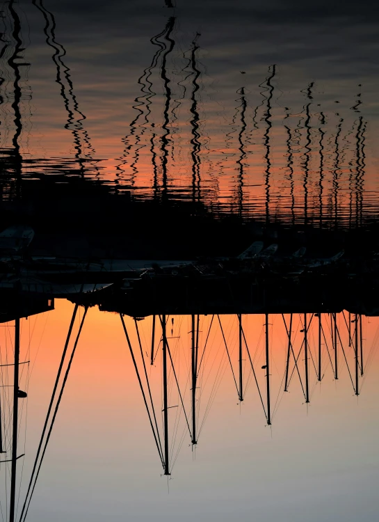 the sun is setting behind the large ship dock