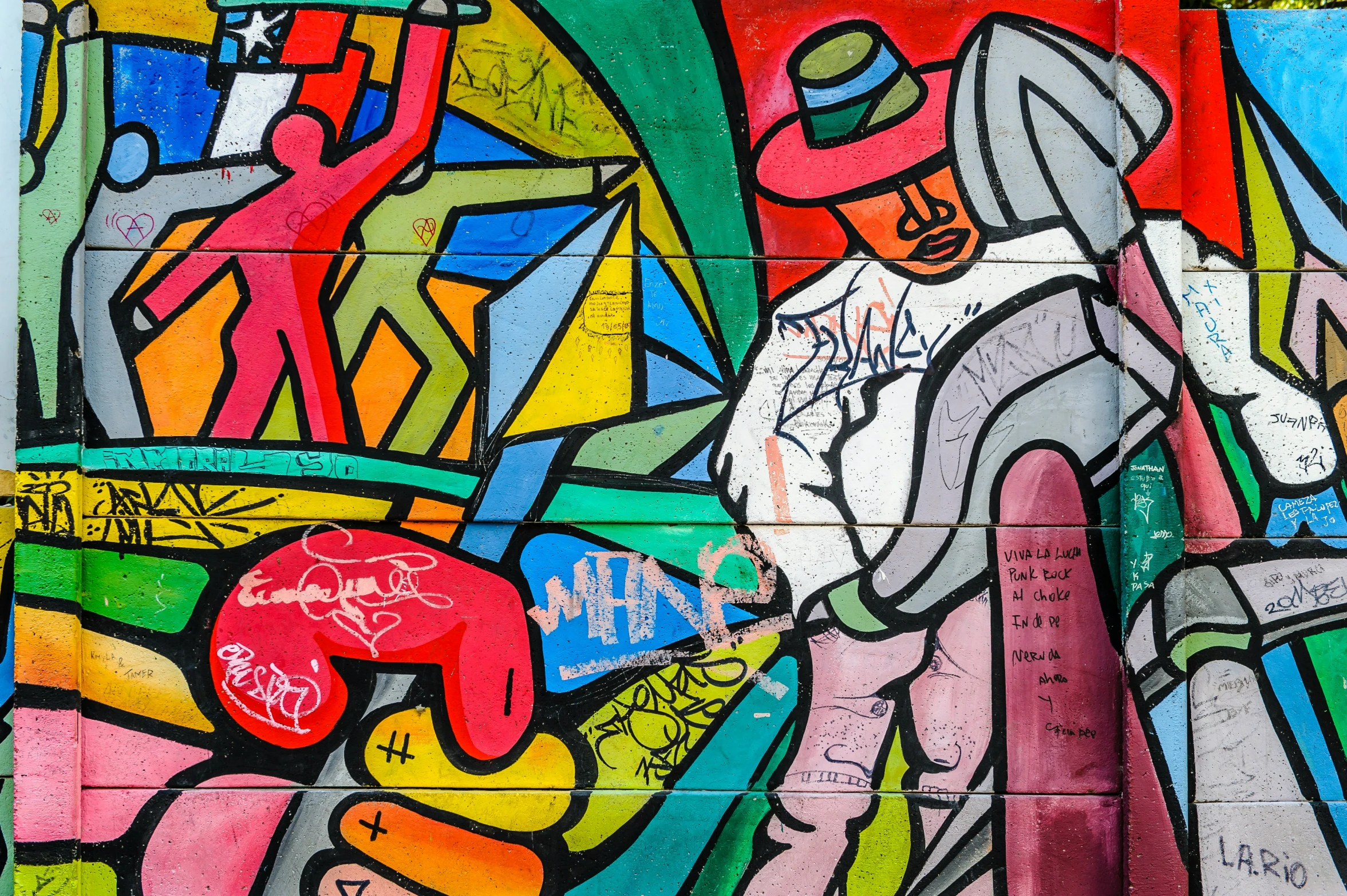 a wall painting depicting a baseball player and other graffiti