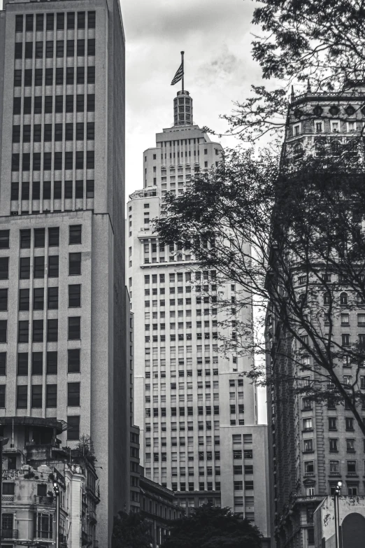 black and white pograph of skyscrs and pedestrians