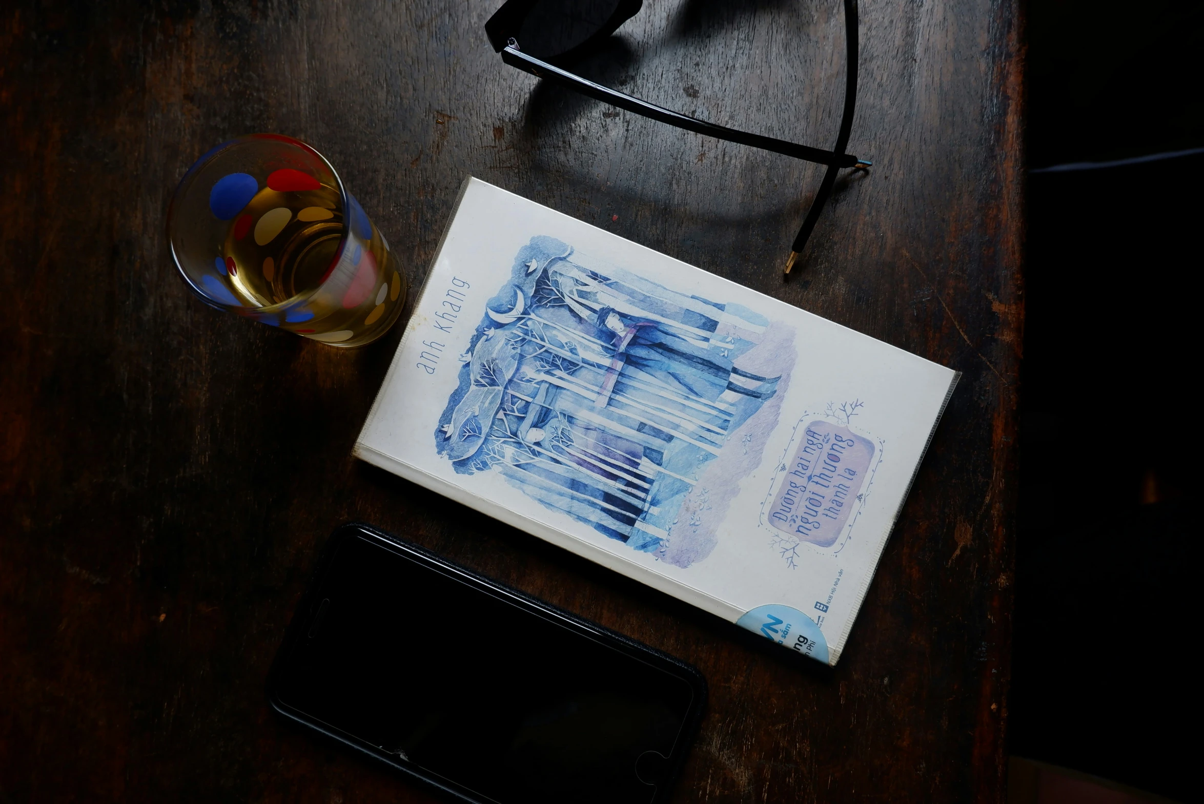 a notepad with a drawing on it next to glasses