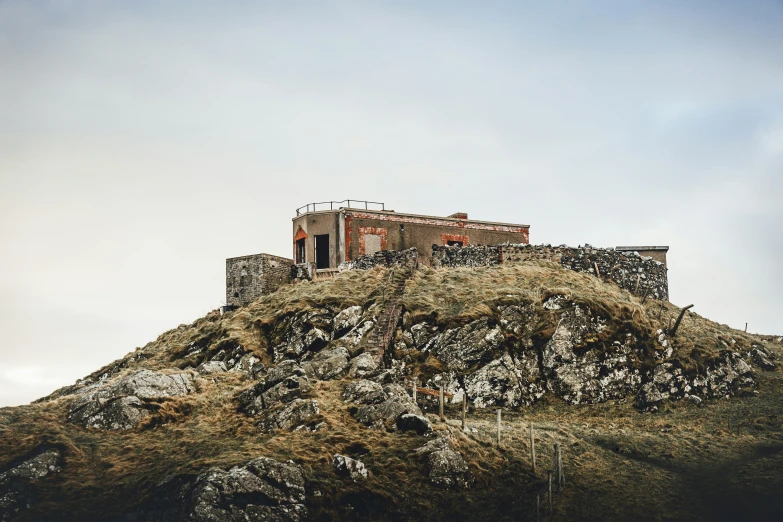 a tall rock with a building on top