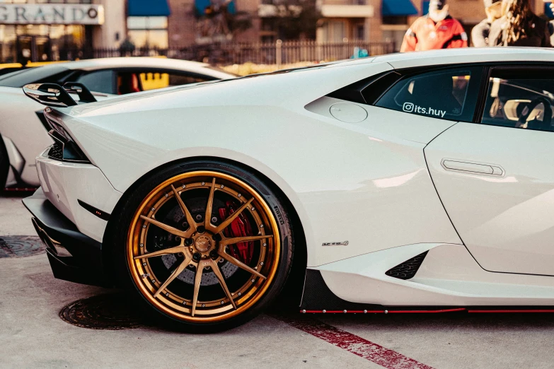 white sports car parked next to a woman