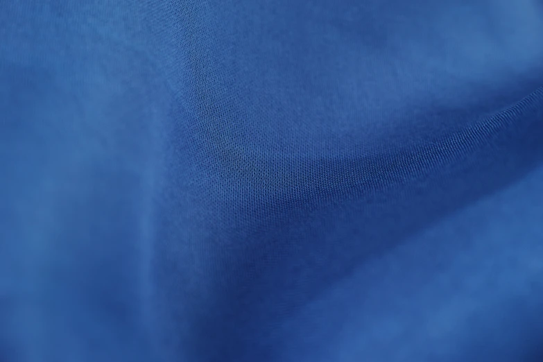 the top of a blue shirt with some stitching on it