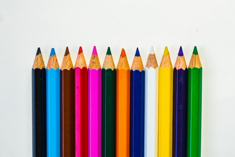 a set of twelve colored pencils lined up and arranged