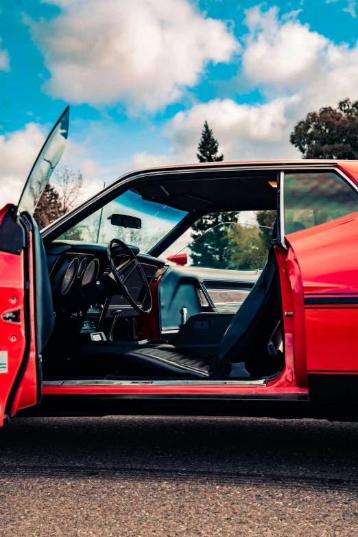 a large red car with its door open