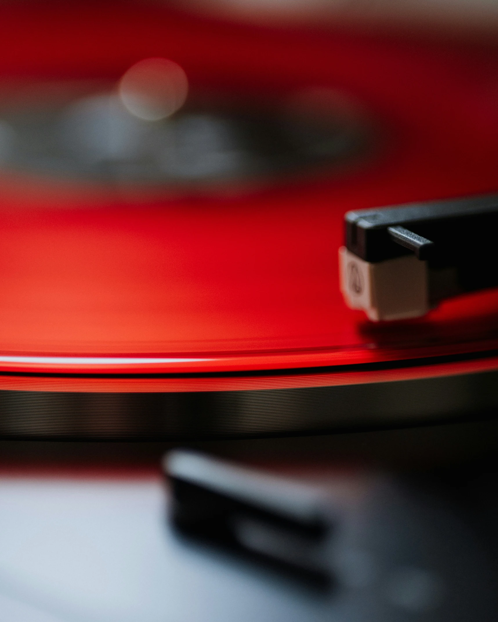 closeup of a red turntable sitting on a table