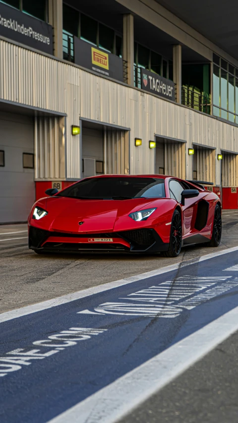 a red sports car parked by a wall