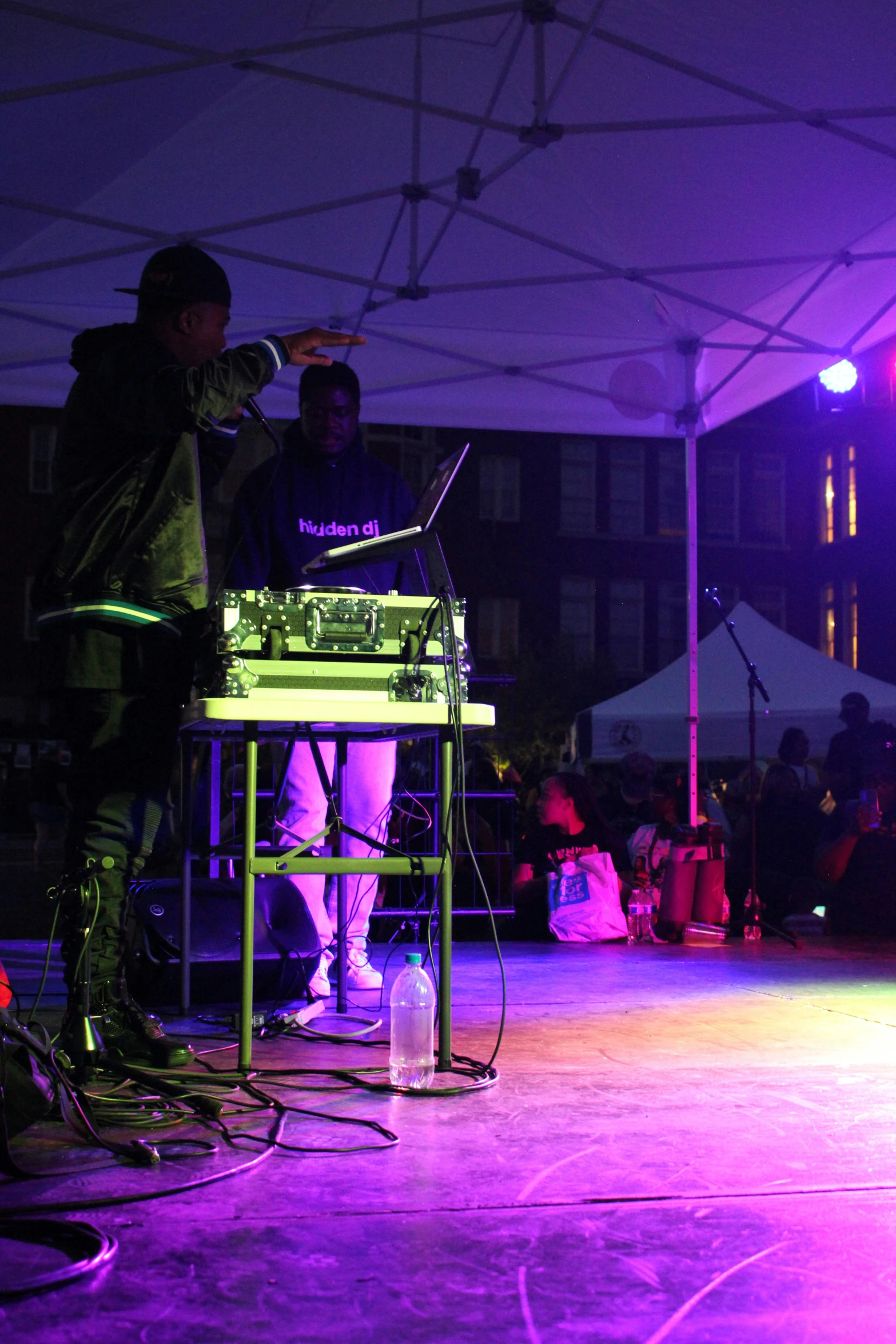 man playing with dj equipment at night at party